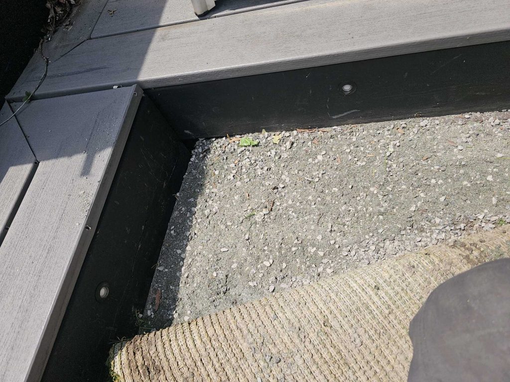 Artificial grass edge detail showing clean transition to stone base