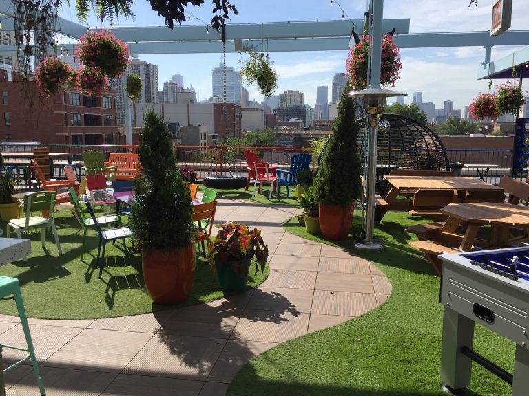 Urban courtyard with artificial grass pathways and large planters